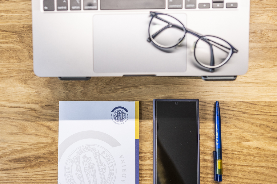 Glasses on the laptop, notebook, mobile phone, pen from above